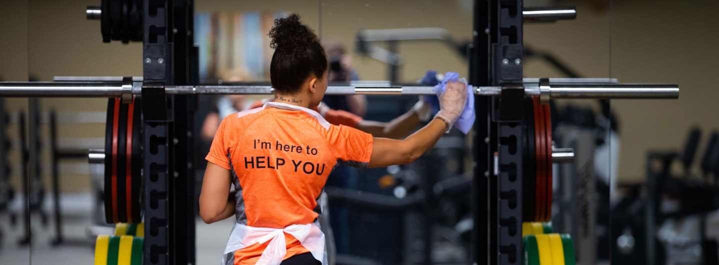 Image of team member cleaning gym equipment at David Lloyd