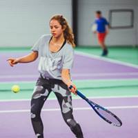 Image of girl hitting a forehand on tennis court